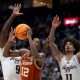 Texas Longhorns guard Tramon Mark (12) grabs a rebound in front of Texas A&M forward Solomon Washington (9) and forward Andersson Garcia (11) during their second round game of the SEC Men's Basketball Tournament at Bridgestone Arena in Nashville, Tenn., Thursday, March 13, 2025.