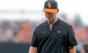 Oklahoma State assistant Coach Rob Walton walks off the field after talking to Oklahoma State utility Nolan McLean (13) during a game in the NCAA Stillwater Regional between the Oklahoma State Cowboys (OSU) and the Oral Roberts Golden Eagles at O'Brate Stadium in Stillwater, Okla., on Friday, June 2, 2023.