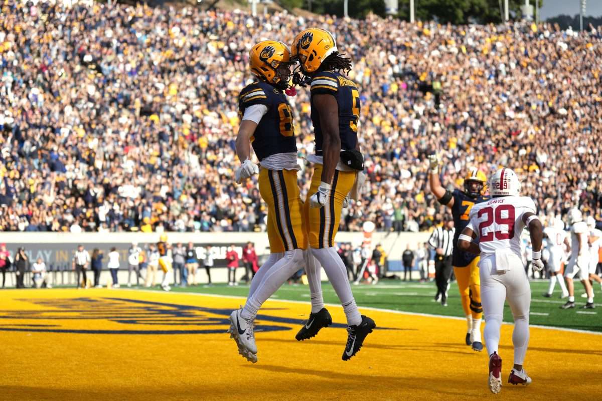 Nov 23, 2024; Berkeley, California, USA; California Golden Bears wide receiver Trond Grizzell (center left) celebrates with wide receiver Tobias Merriweather (center right) after scoring a touchdown against the Stanford Cardinal during the second quarter at California Memorial Stadium. Mandatory Credit: Darren Yamashita-Imagn Images
