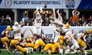 The Texas defense reach, attempting to block a field goal attempt from Arizona State Sun Devils kicker Carston Kieffer (26) in the first quarter as the Texas Longhorns play the Arizona State Sun Devils in the Peach Bowl College Football Playoff quarterfinal at Mercedes-Benz Stadium in Atlanta, Georgia, Jan. 1, 2025.