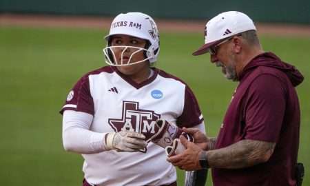 Texas A&M assistant coach Russ Heffley talks to infielder Mya Perez 24) on first base during the NCAA D1 Softball Tournament Regional against Saint Francis University at Davis Diamond at Texas A&M University on Friday, May 16, 2025 in College Station, Texas.