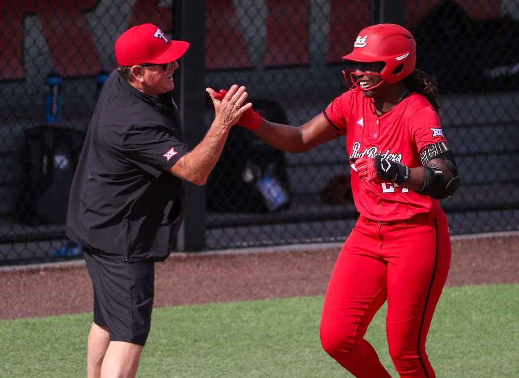 Texas Tech's NiJaree Canady high-fives head coach Gerry Glasco after hitting a home run against Brown during a game in the Lubbock Regional as part of the 2025 NCAA softball tournament, Friday, May 16, 2025, at Rocky Johnson Field.