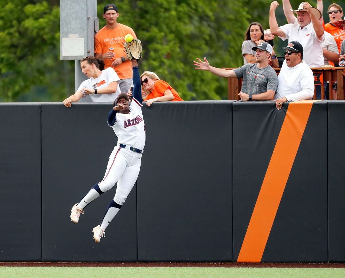 Arizona's Dakota Kennedy (4) can not catch the home run ball of Oklahoma State's Tallen Edwards in the first inning of Game 2 of the NCAA softball tournament Stillwater Super Regional between the Oklahoma State Cowgirls and the Arizona Wildcats in Stillwater, Okla., Saturday, May, 25, 2024.