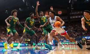 Kansas freshman guard Elmarko Jackson (13) drives the ball against Baylor players in the second half of the game Saturday, February 10, 2024 inside Allen Fieldhouse.