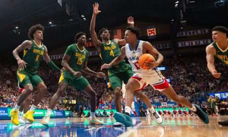 Kansas freshman guard Elmarko Jackson (13) drives the ball against Baylor players in the second half of the game Saturday, February 10, 2024 inside Allen Fieldhouse.