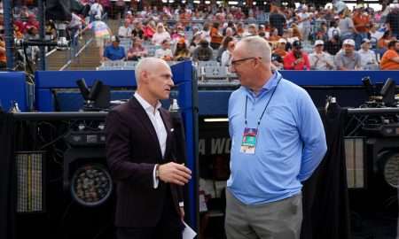 Big 12 commissioner is Brett Yormark, left, and SEC commissioner Greg Sankey talk before Game 1 of the Women's College World Series championship series between the Texas Longhorns at Texas Tech Red Raiders at Devon Park in Oklahoma City, Wednesday, June 4, 2025. Texas won 2-1.