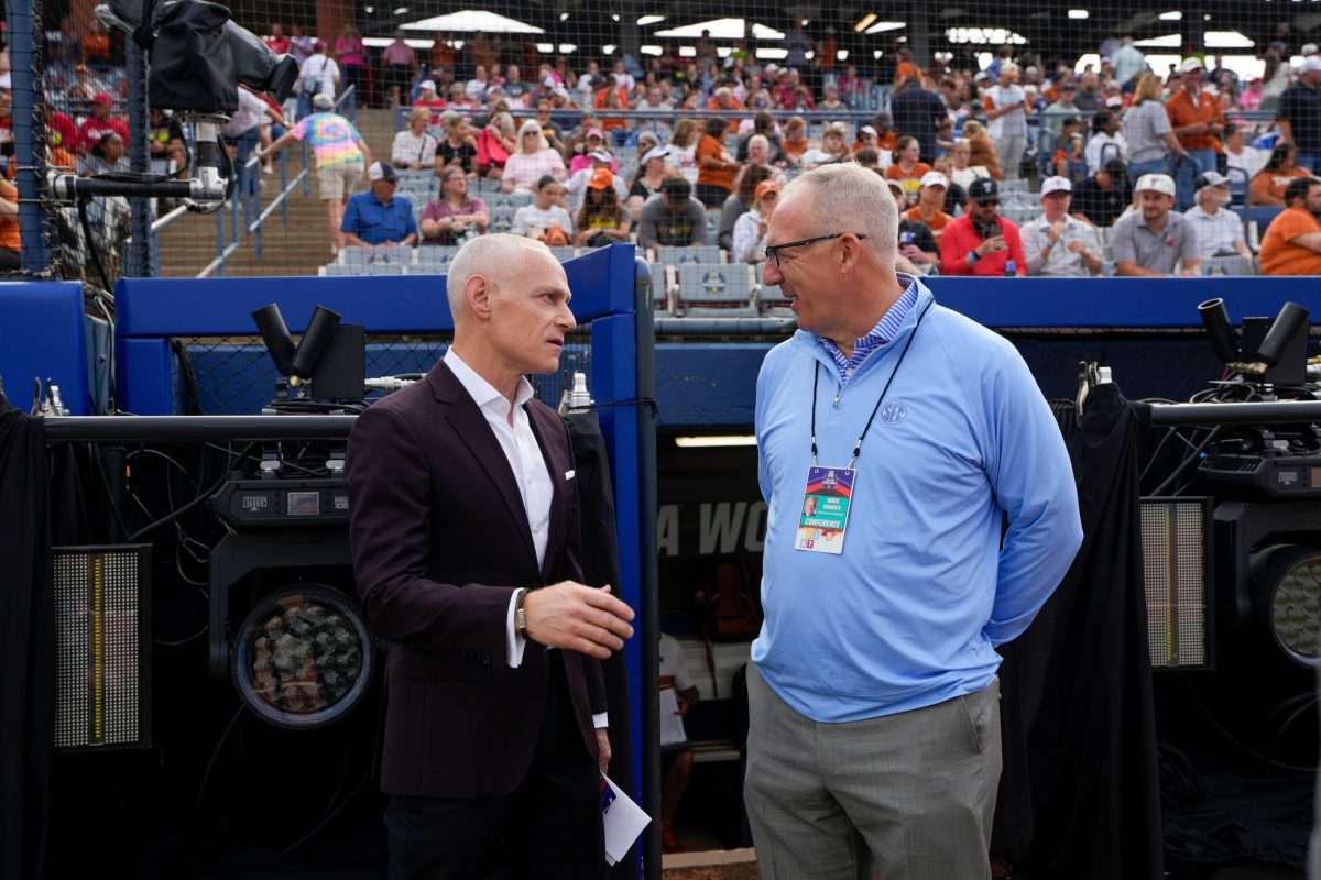 Big 12 commissioner is Brett Yormark, left, and SEC commissioner Greg Sankey talk before Game 1 of the Women's College World Series championship series between the Texas Longhorns at Texas Tech Red Raiders at Devon Park in Oklahoma City, Wednesday, June 4, 2025. Texas won 2-1.