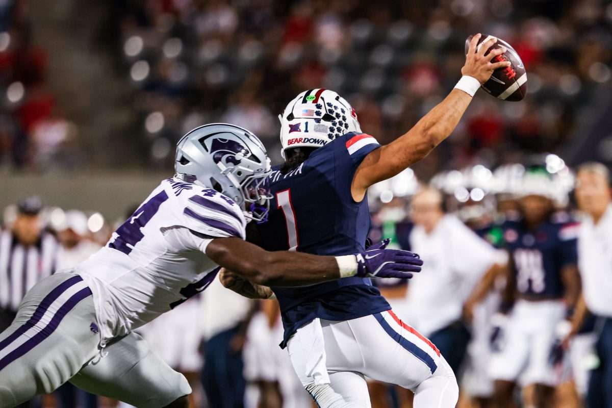 Sep 12, 2025; Tucson, Arizona, USA; Kansas State Wildcats defensive end Tobi Osunsanmi (44) tackles Arizona Wildcats quarterback Noah Fifita (1) during the third quarter of the game at Arizona Stadium. Mandatory Credit: Aryanna Frank-Imagn Images