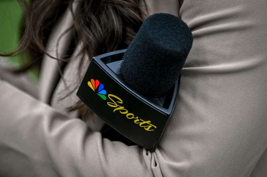 A Peacock sideline reporter holds a microphone with the NBC Peacock logo during Michigan State's football game against Washington on Saturday, Sept. 16, 2023 at Spartan Stadium in East Lansing, Michigan.