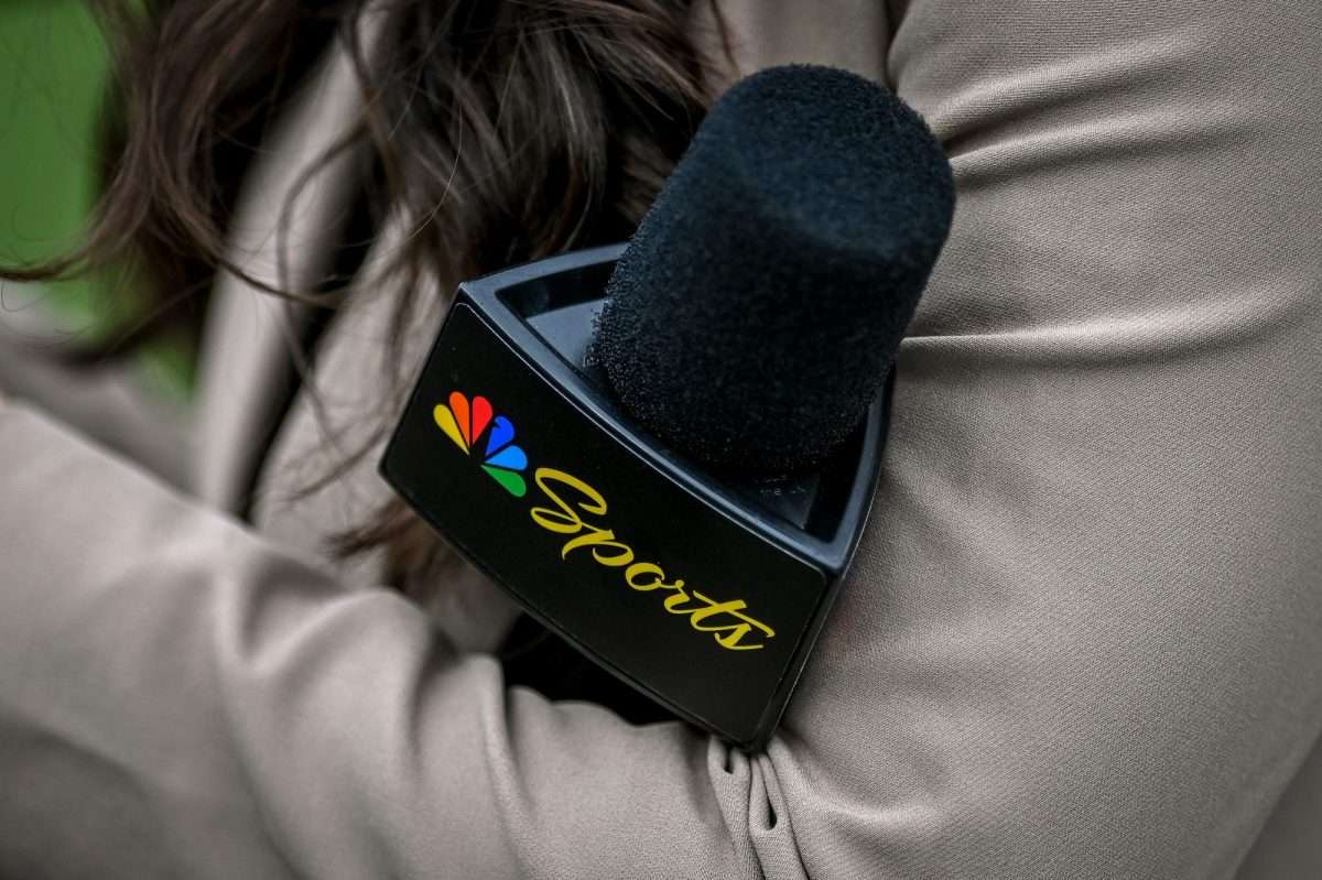 A Peacock sideline reporter holds a microphone with the NBC Peacock logo during Michigan State's football game against Washington on Saturday, Sept. 16, 2023 at Spartan Stadium in East Lansing, Michigan.