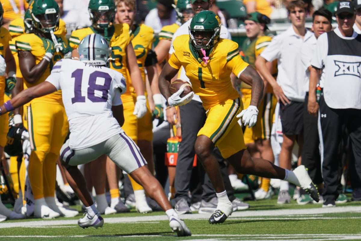 Oct 4, 2025; Waco, Texas, USA; Baylor Bears tight end Michael Trigg (1) runs after the catch against Kansas State Wildcats safety Wesley Fair (18) during the first half at McLane Stadium. Mandatory Credit: Chris Jones-Imagn Images