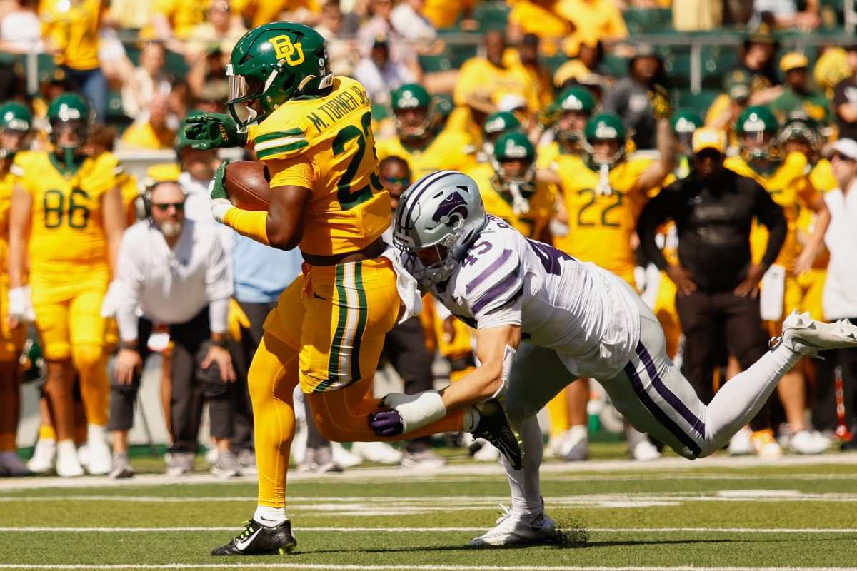 Oct 4, 2025; Waco, Texas, USA; Baylor Bears running back Michael Turner (23) runs the ball for a touchdown against Kansas State Wildcats linebacker Austin Romaine (45) during the first half at McLane Stadium. Mandatory Credit: Chris Jones-Imagn Images