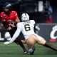 Cincinnati Bearcats quarterback Brendan Sorsby (2) runs as UCF Knights edge Isaiah Nixon (6) attempts to tackle him in the second quarter of the NCAA football game between the Cincinnati Bearcats and UCF Knights at Nippert Stadium in Cincinnati on Oct. 11, 2025.