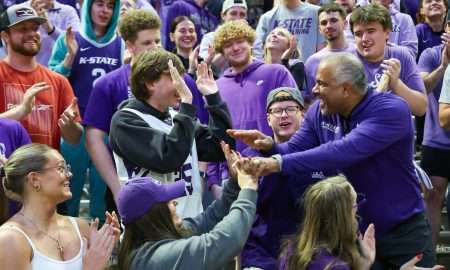 Nov 17, 2025; Manhattan, Kansas, USA; Kansas State Wildcats head coach Jerome Tang celebrates with students in the stands following a win against the Tulsa Golden Hurricane at Bramlage Coliseum. Mandatory Credit: Scott Sewell-Imagn Images