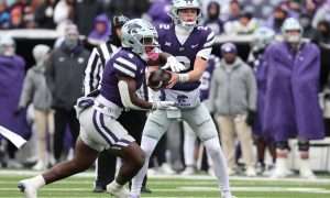 Nov 29, 2025; Manhattan, Kansas, USA; Kansas State Wildcats running back Joe Jackson (4) takes the handoff from quarterback Avery Johnson (2) during the fourth quarter at Bill Snyder Family Football Stadium. Mandatory Credit: Scott Sewell-Imagn Images