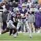 Nov 29, 2025; Manhattan, Kansas, USA; Kansas State Wildcats running back Joe Jackson (4) takes the handoff from quarterback Avery Johnson (2) during the fourth quarter at Bill Snyder Family Football Stadium. Mandatory Credit: Scott Sewell-Imagn Images