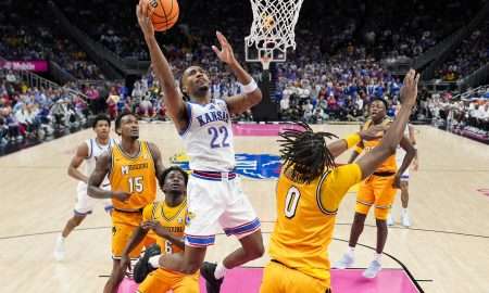 Dec 7, 2025; Kansas City, Missouri, USA; Kansas Jayhawks guard Darryn Peterson (22) shoots during the first half against the Missouri Tigers at T-Mobile Center. Mandatory Credit: Jay Biggerstaff-Imagn Images