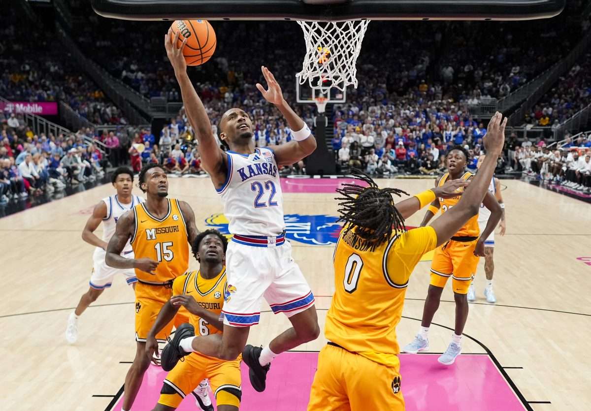 Dec 7, 2025; Kansas City, Missouri, USA; Kansas Jayhawks guard Darryn Peterson (22) shoots during the first half against the Missouri Tigers at T-Mobile Center. Mandatory Credit: Jay Biggerstaff-Imagn Images