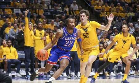 Jan 10, 2026; Morgantown, West Virginia, USA; Kansas Jayhawks guard Darryn Peterson (22) drives baseline past West Virginia Mountaineers guard Treysen Eaglestaff (52) during the first half at Hope Coliseum. Mandatory Credit: Ben Queen-Imagn Images