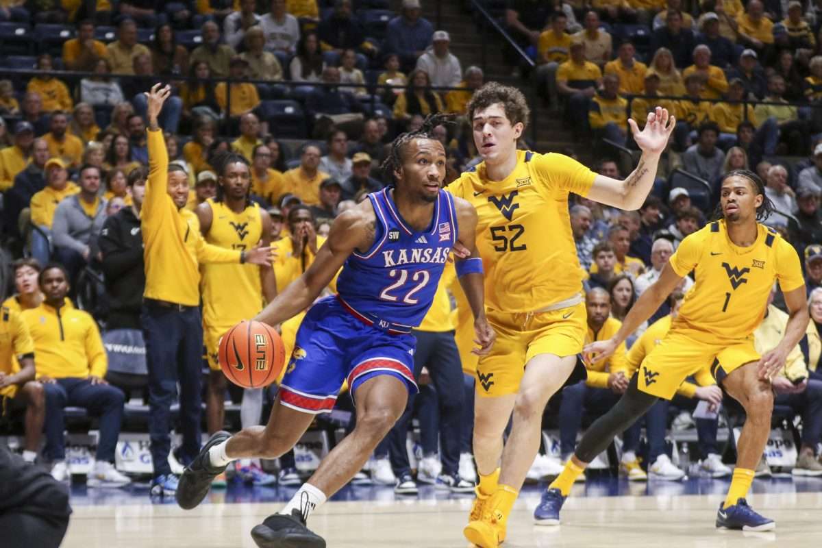 Jan 10, 2026; Morgantown, West Virginia, USA; Kansas Jayhawks guard Darryn Peterson (22) drives baseline past West Virginia Mountaineers guard Treysen Eaglestaff (52) during the first half at Hope Coliseum. Mandatory Credit: Ben Queen-Imagn Images