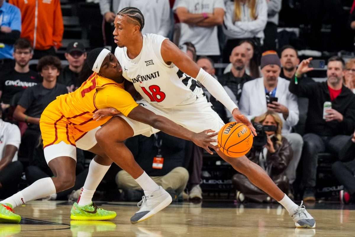 Jan 17, 2026; Cincinnati, Ohio, USA; Iowa State Cyclones guard Killyan Toure (27) steals the ball from Cincinnati Bearcats forward Baba Miller (18) in the first half at Fifth Third Arena. Mandatory Credit: Aaron Doster-Imagn Images