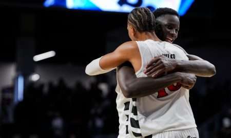 Feb 15, 2026; Cincinnati, Ohio, USA; Cincinnati Bearcats center Moustapha Thiam, back, hugs forward Baba Miller after their team’s win against the Utah Utes at Fifth Third Arena. Mandatory Credit: Aaron Doster-Imagn Images