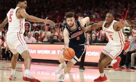 Feb 21, 2026; Houston, Texas, USA; Arizona Wildcats guard Anthony Dell'orso (3) splits the defense of Houston Cougars center Chris Cenac Jr. (5) and guard Mercy Miller (25) in the first half at Fertitta Center. Mandatory Credit: Thomas Shea-Imagn Images