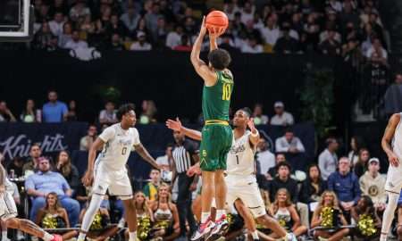 Feb 28, 2026; Orlando, Florida, USA; Baylor Bears guard Isaac Williams (10) shoots a three point basket in front of UCF Knights guard Themus Fulks (1) during the first half at Addition Financial Arena. Mandatory Credit: Mike Watters-Imagn Images