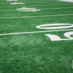 empty generic football field heartland college sports football news